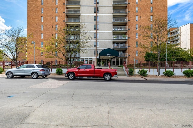 view of apartment building / complex with fence