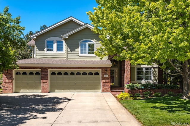 10859 Irving Ct, Westminster, CO 80031 - view of front of home with brick siding, an attached garage, driveway, and a front lawn