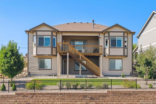 rear view of property with stairs and fence