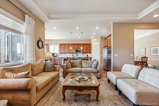 living area with light wood-style floors, recessed lighting, and crown molding