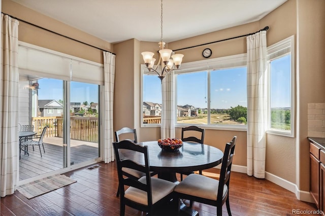 dining space featuring dark wood-style floors, plenty of natural light, visible vents, and baseboards