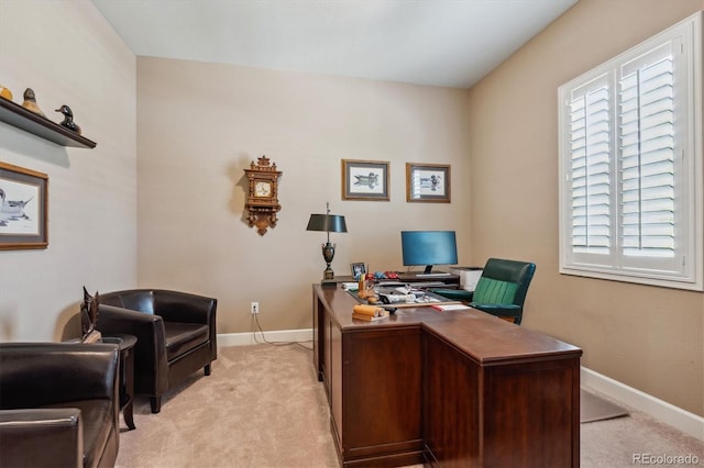 office with baseboards and light colored carpet