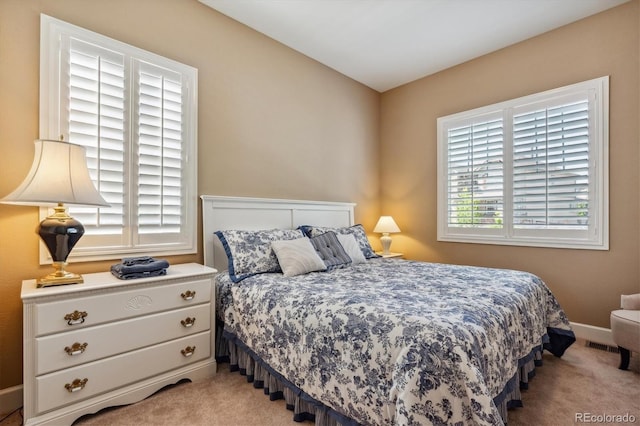 bedroom featuring light carpet