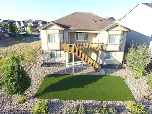 view of playground featuring a yard, stairs, a residential view, and a wooden deck