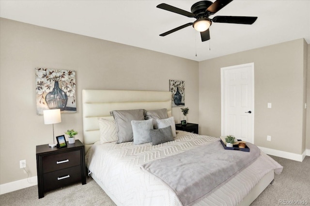 bedroom with light carpet, baseboards, and a ceiling fan