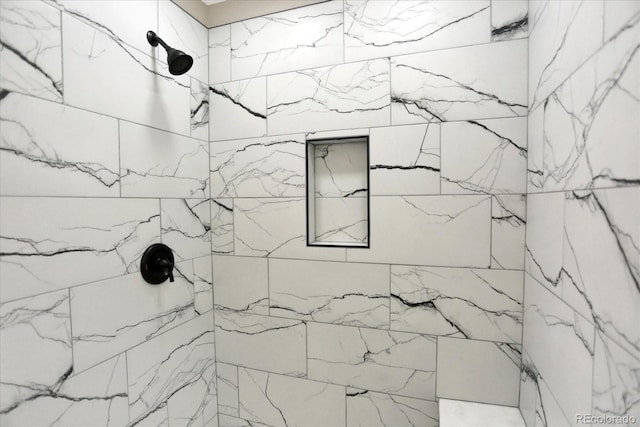 bathroom with a tile shower