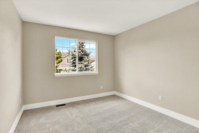 unfurnished room with carpet floors and baseboards