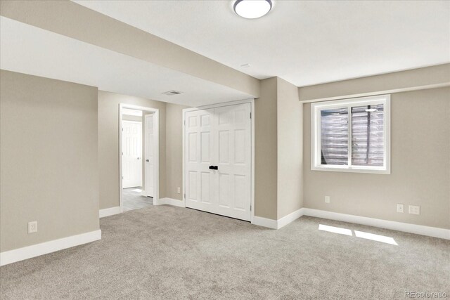 below grade area featuring carpet and baseboards