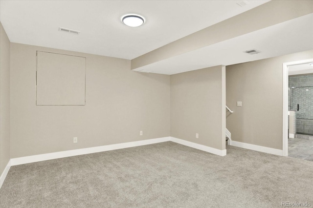 finished below grade area featuring baseboards, carpet, and stairs