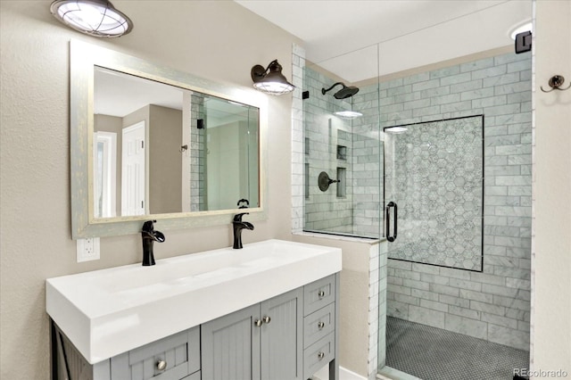 bathroom featuring a shower stall and vanity