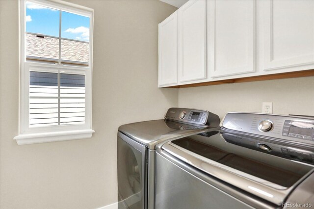 laundry room with cabinet space and separate washer and dryer