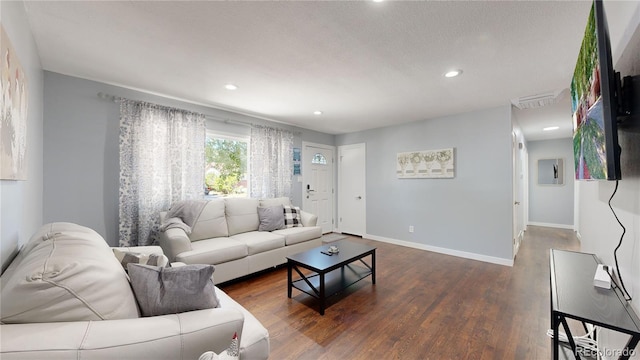 living area featuring dark wood-type flooring, recessed lighting, visible vents, and baseboards