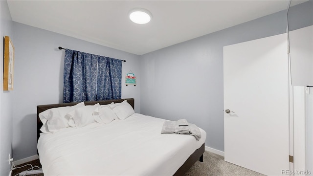 bedroom featuring carpet flooring and baseboards