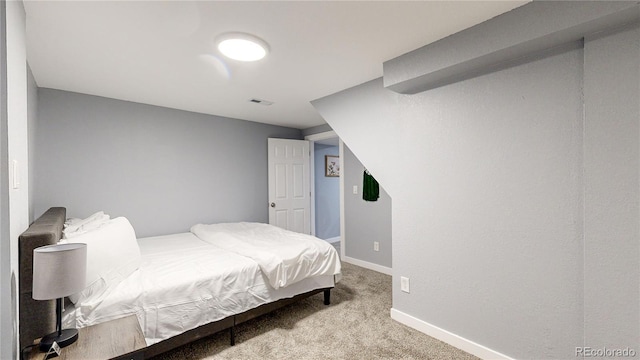 carpeted bedroom with visible vents and baseboards