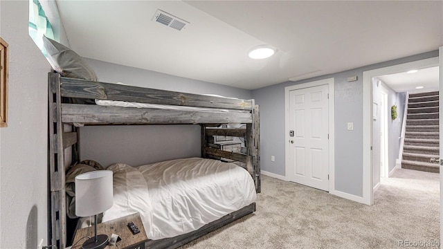 bedroom featuring light carpet, visible vents, and baseboards