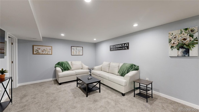 living room with recessed lighting, light colored carpet, and baseboards