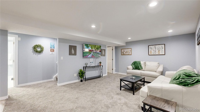 living room with recessed lighting, light carpet, and baseboards