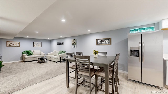 dining space with baseboards, light wood-type flooring, and recessed lighting