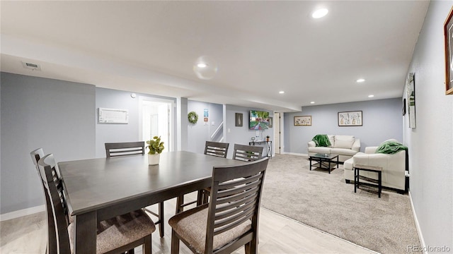 dining room featuring baseboards, light colored carpet, visible vents, and recessed lighting