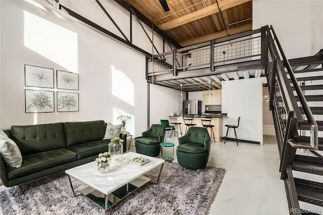 living room with a towering ceiling and wooden ceiling