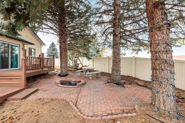 view of patio / terrace featuring a deck and a fire pit