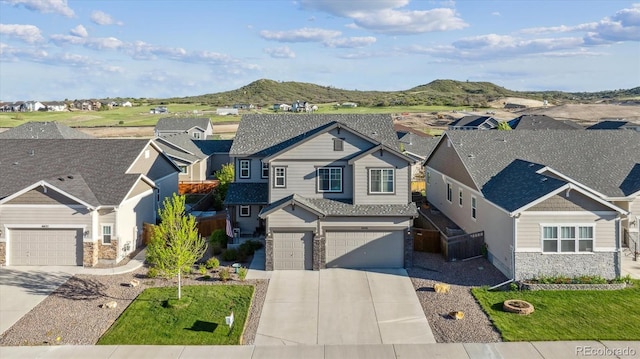 6616 Amur Ln, Castle Rock, CO 80108 - view of front facade featuring a residential view, driveway, stone siding, and a mountain view