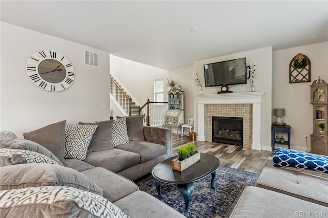 6616 Amur Ln, Castle Rock, CO 80108 - living room featuring wood finished floors, stairway, a fireplace, and baseboards