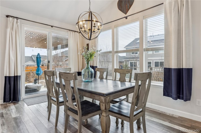 6616 Amur Ln, Castle Rock, CO 80108 - dining space with baseboards, a chandelier, and hardwood / wood-style flooring