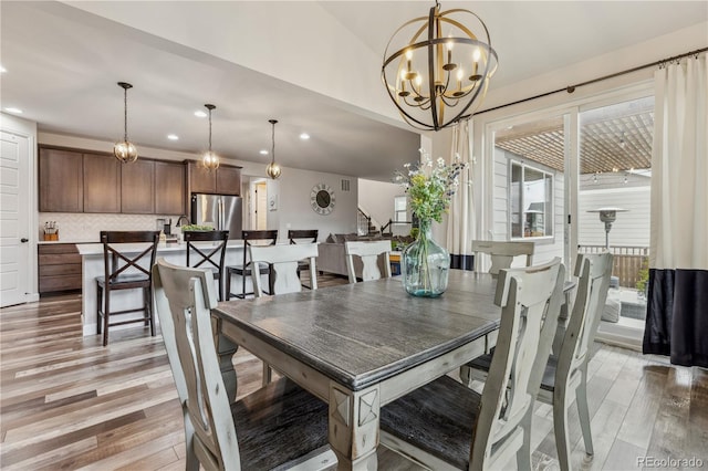 6616 Amur Ln, Castle Rock, CO 80108 - dining space with recessed lighting, light wood-style flooring, a chandelier, and vaulted ceiling