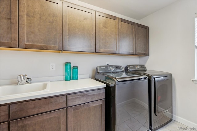 6616 Amur Ln, Castle Rock, CO 80108 - laundry area with cabinet space, washing machine and clothes dryer, light tile patterned floors, and baseboards