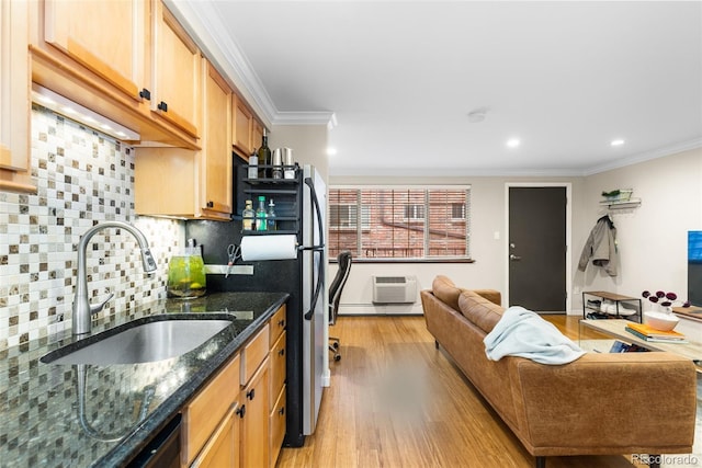 kitchen featuring dark stone countertops, crown molding, sink, and tasteful backsplash