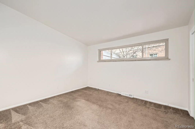 4585/4587 E Yale Ave, Denver, CO 80222 - empty room with carpet flooring, vaulted ceiling, and baseboards