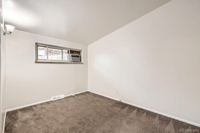 4585/4587 E Yale Ave, Denver, CO 80222 - empty room featuring dark colored carpet, baseboards, and lofted ceiling