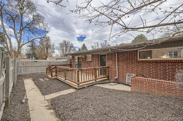 4585/4587 E Yale Ave, Denver, CO 80222 - back of property featuring brick siding, a fenced backyard, and a wooden deck