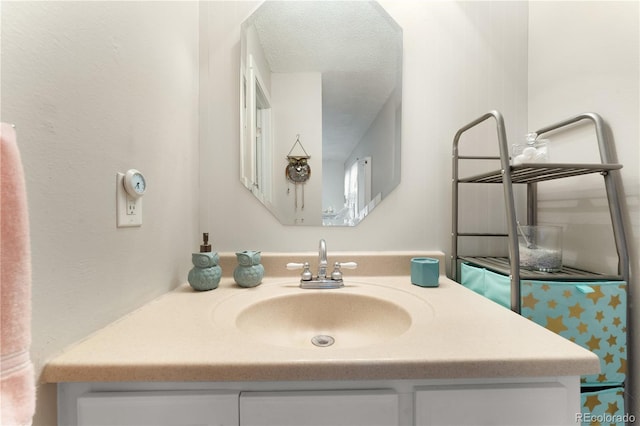 bathroom featuring a textured ceiling and vanity