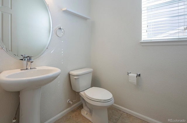 bathroom with sink, tile patterned flooring, and toilet