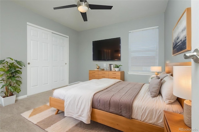 bedroom with light carpet, a closet, and ceiling fan