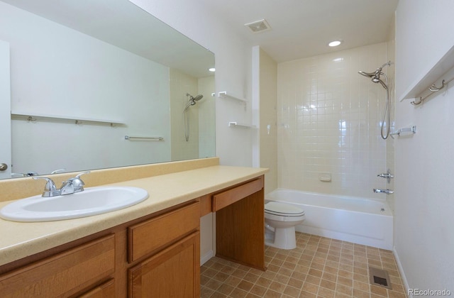 full bathroom featuring vanity, tiled shower / bath combo, and toilet