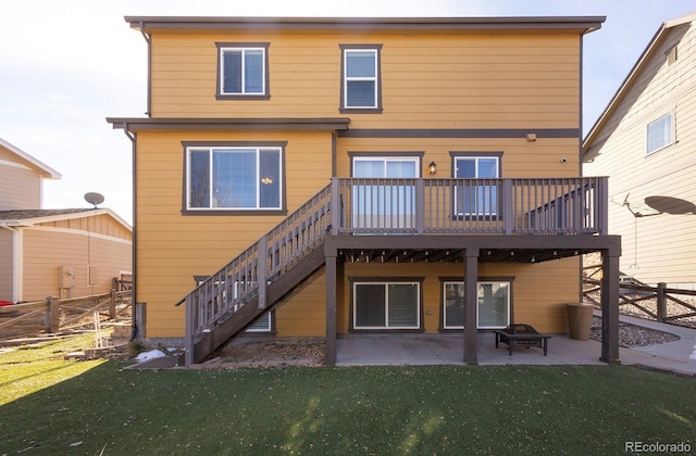 back of property featuring a yard, a deck, and a patio area