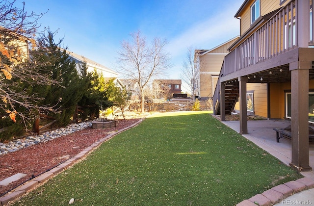 view of yard with a patio area and a wooden deck