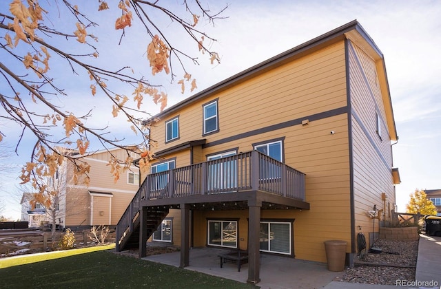 back of house with a lawn, a patio area, and a deck