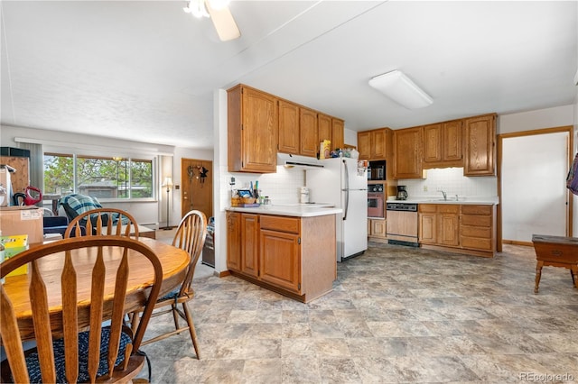 kitchen with dishwashing machine, a sink, black microwave, light countertops, and backsplash