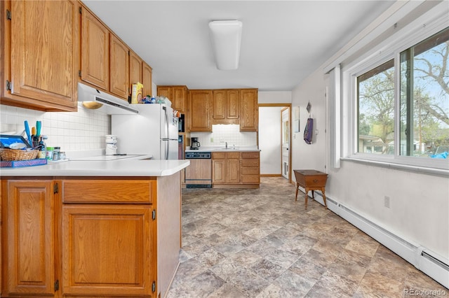kitchen with under cabinet range hood, dishwasher, a sink, backsplash, and light countertops
