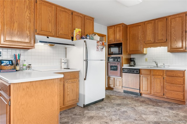 kitchen featuring paneled dishwasher, oven, under cabinet range hood, a sink, and black microwave