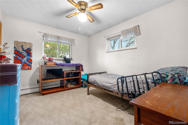 carpeted bedroom featuring ceiling fan and a baseboard radiator