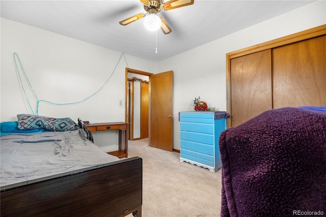 bedroom with light carpet, a ceiling fan, and a closet