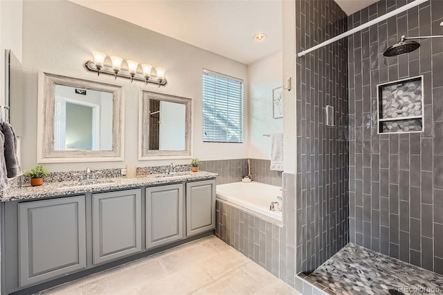 4037 S Odessa Cir, Aurora, CO 80013 - bathroom featuring a sink, tile patterned flooring, double vanity, tiled shower, and a garden tub