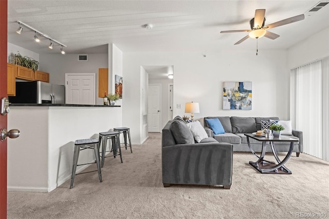 4451 S Ammons St Unit 4-203, Littleton, CO 80123 - living room featuring light colored carpet, ceiling fan, rail lighting, and baseboards
