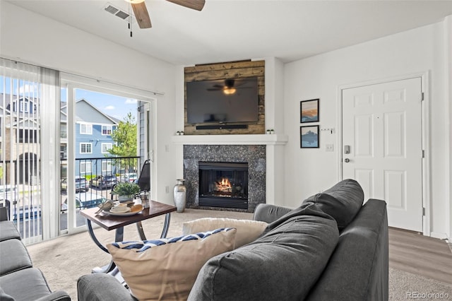 4451 S Ammons St Unit 4-203, Littleton, CO 80123 - living room with a ceiling fan, a fireplace, and carpet flooring