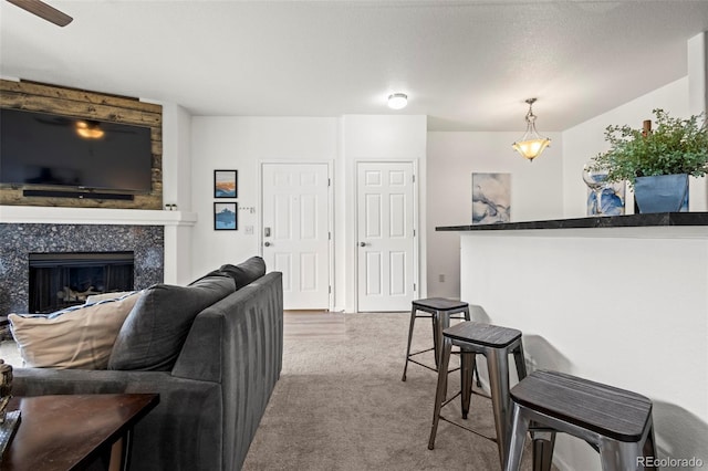 4451 S Ammons St Unit 4-203, Littleton, CO 80123 - living area featuring carpet floors and a tiled fireplace